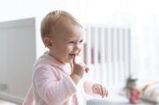 cute-baby-girl-smiling-her-nursery